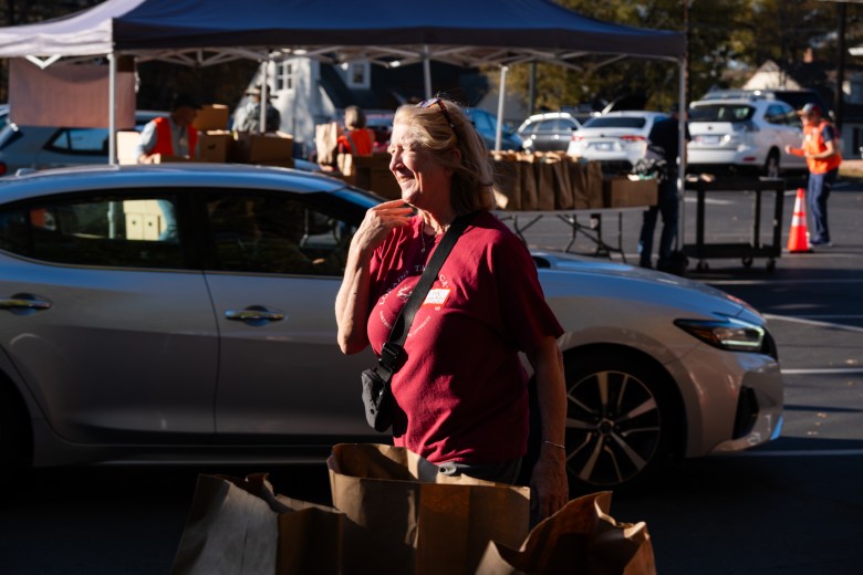 Joy Newburn, Part-time operations manager of Emanuel Food Pantry, helps volunteers during the weekly food distribution. Photo by Cornell Watson. 