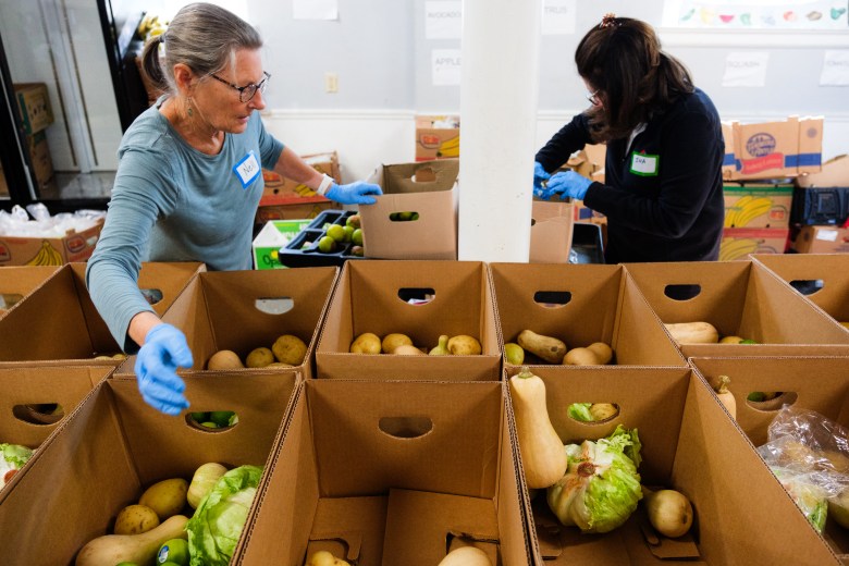 Volunteers at Emmanuel Food Pantry load boxes with produce and food to be handed out during a food distribution. Photo by Cornell Watson. 