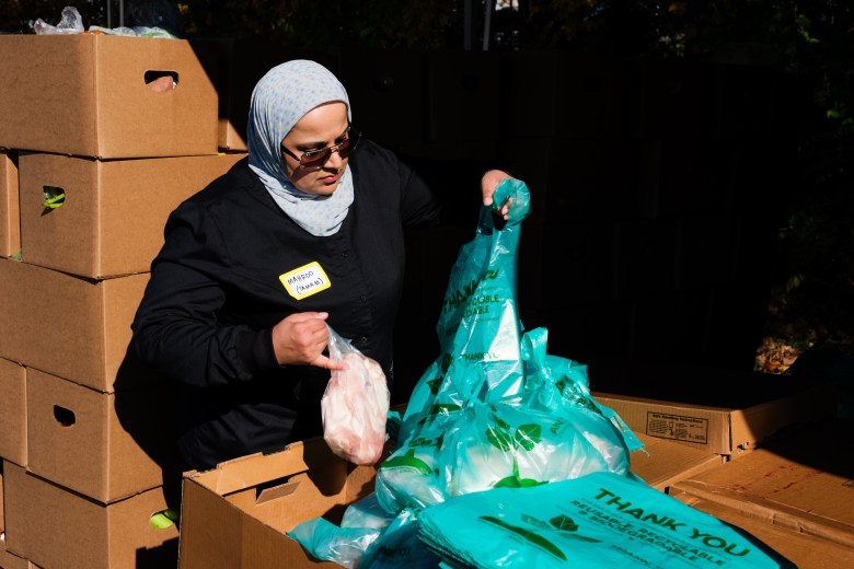 A volunteer sorts food for distribution. Photo by Cornell Watson. 