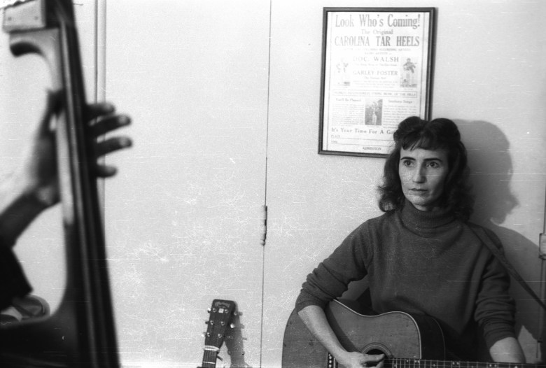 One of our house parties in Washington, DC, 1962. Hazel is sitting under an old flyer for the Carolina Tar Heels. Photo by Jeremy Foster; courtesy Alice Gerrard.