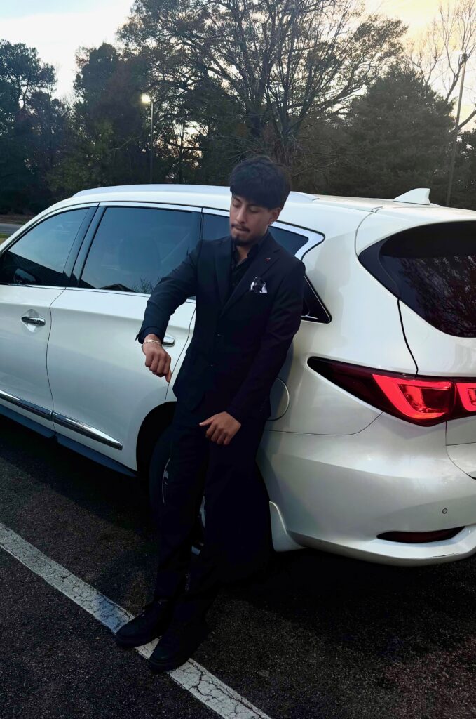 Fernando Vazquez leaning against a car.