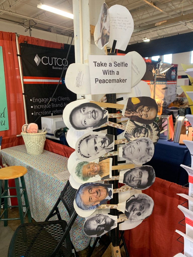 The booth includes a number of options for peacemaker selfies.
