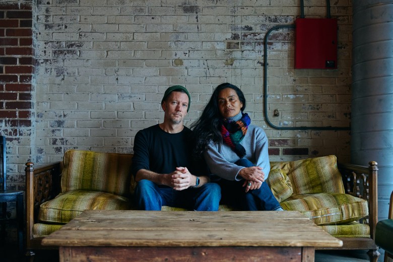 (From left) Tommy Noonan and Murielle Elizéon pose for a portrait in Cup 22, a coffee shop in the Haw River Ballroom, in Saxapahaw, NC. Photo by Matt Ramey. 