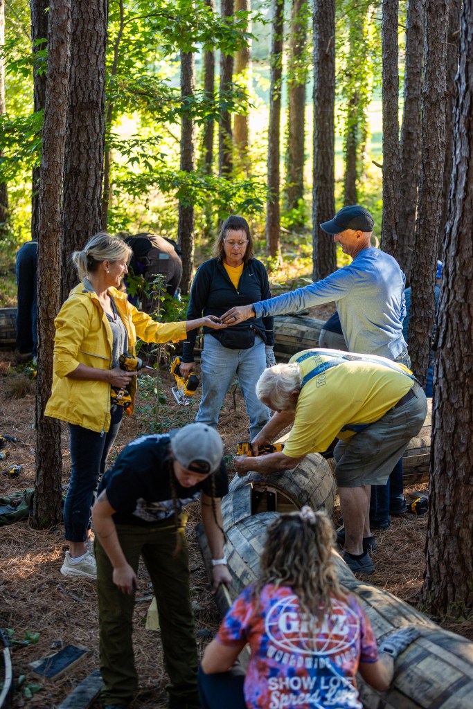 Volunteers help assemble Mother Strongtail's tail. Photo courtesy of Dix Park Conservancy.